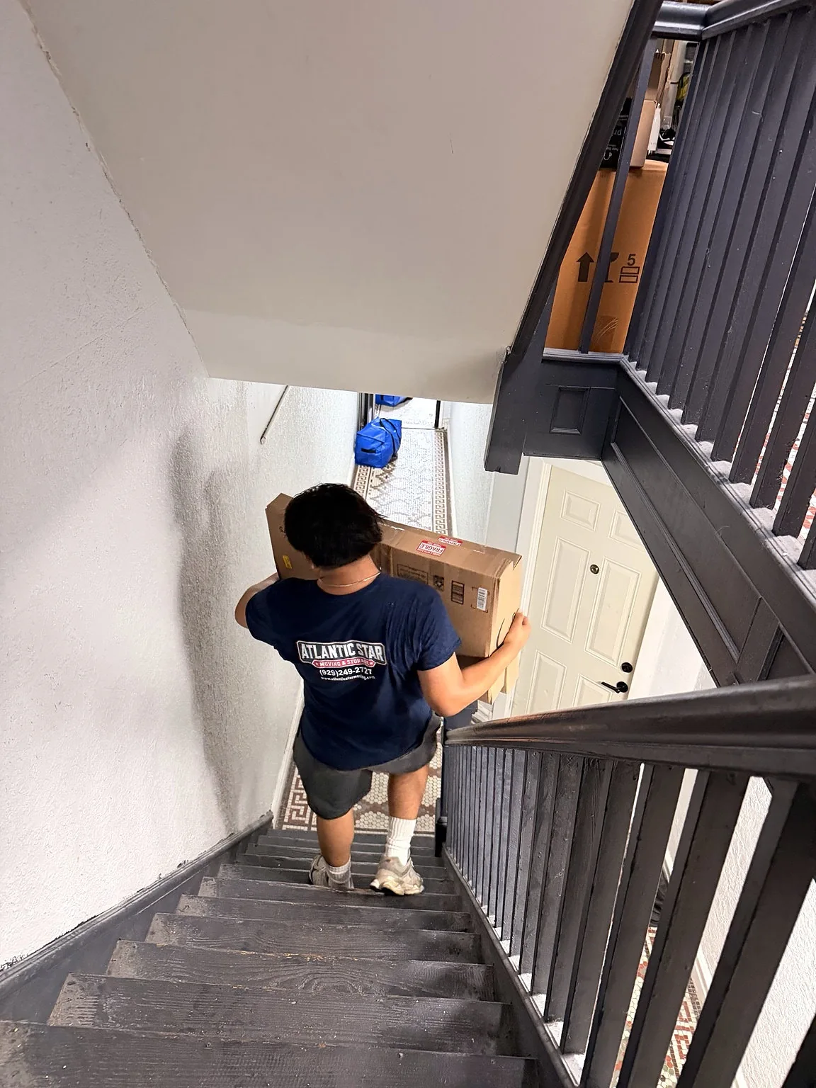 Atlantic Star mover handling furniture on a staircase during a residential job