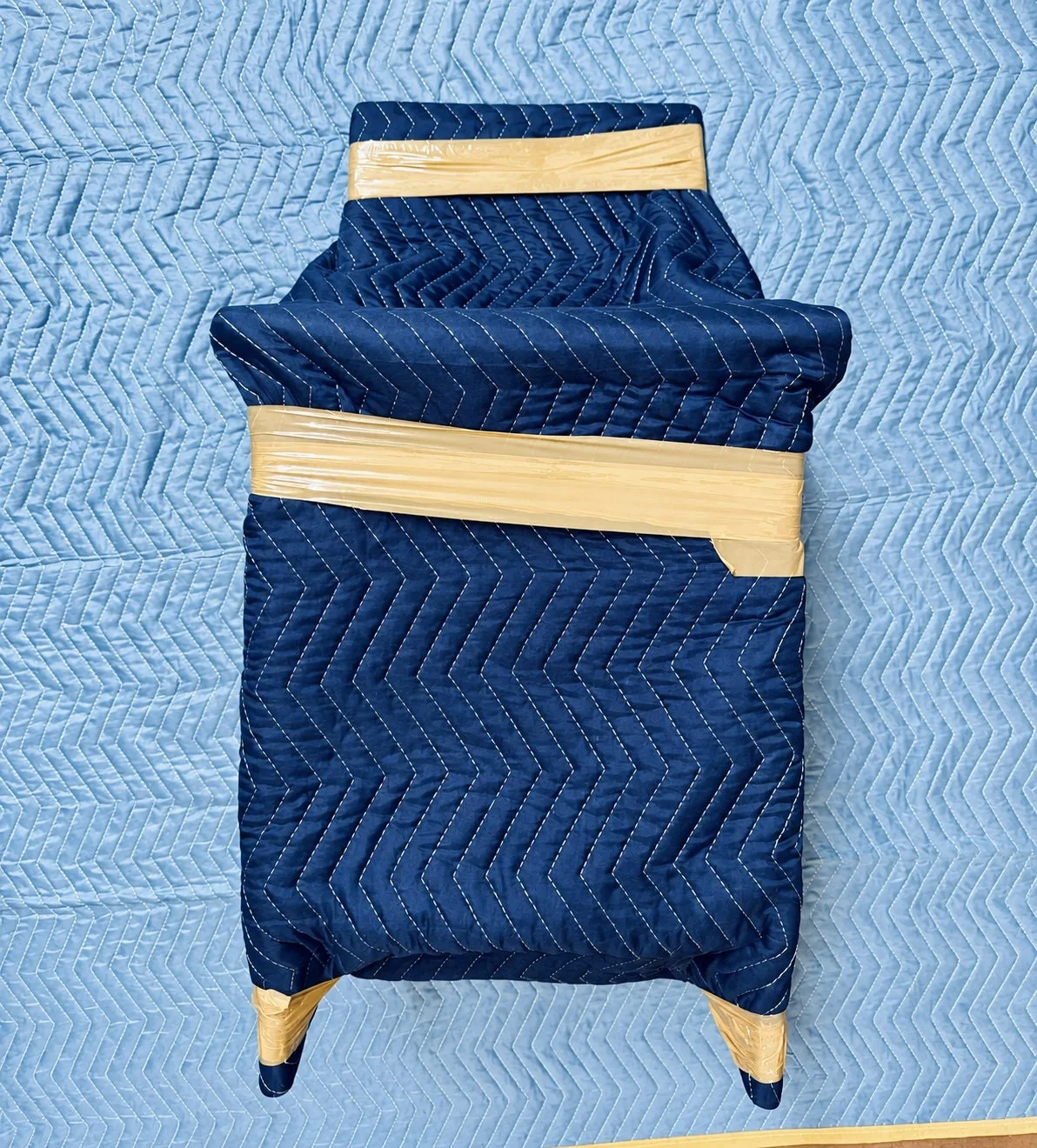 Furniture protected with blue moving blankets during an Atlantic Star moving job