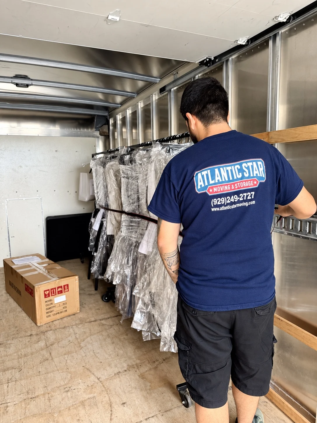 Atlantic Star mover securing hanging garments inside a moving truck