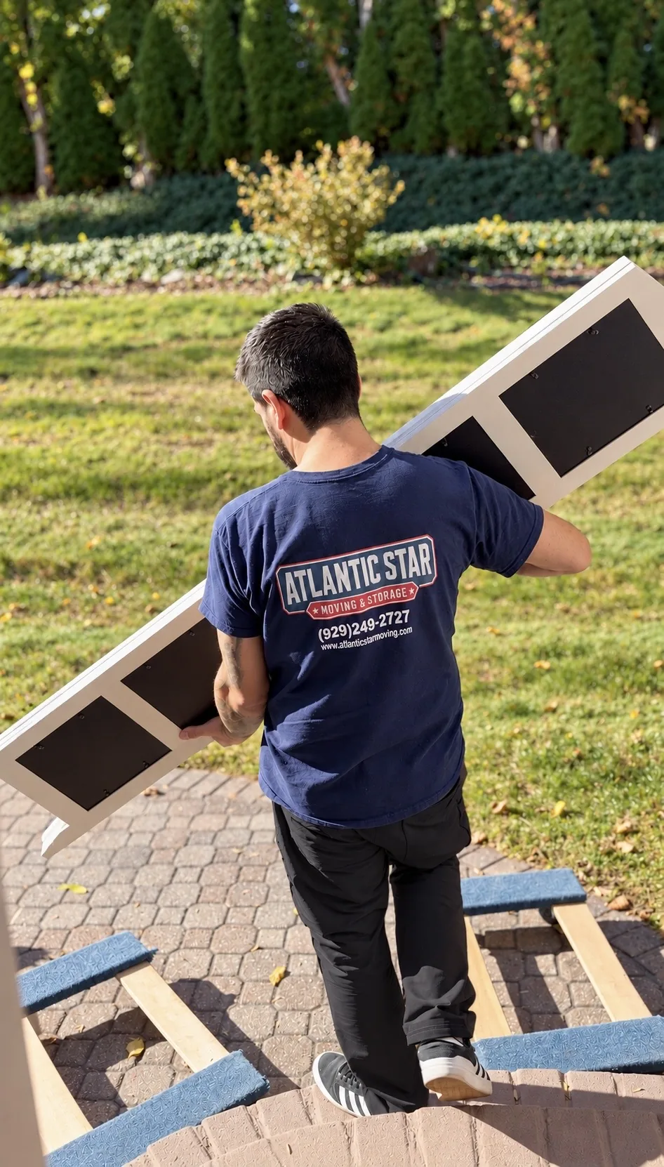 Atlantic Star mover carrying a furniture piece outdoors
