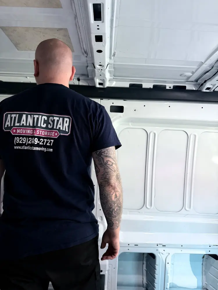 Atlantic Star crew member wearing the company uniform inside a moving van